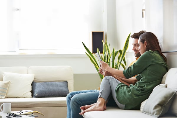 couple watching livestreamed open home