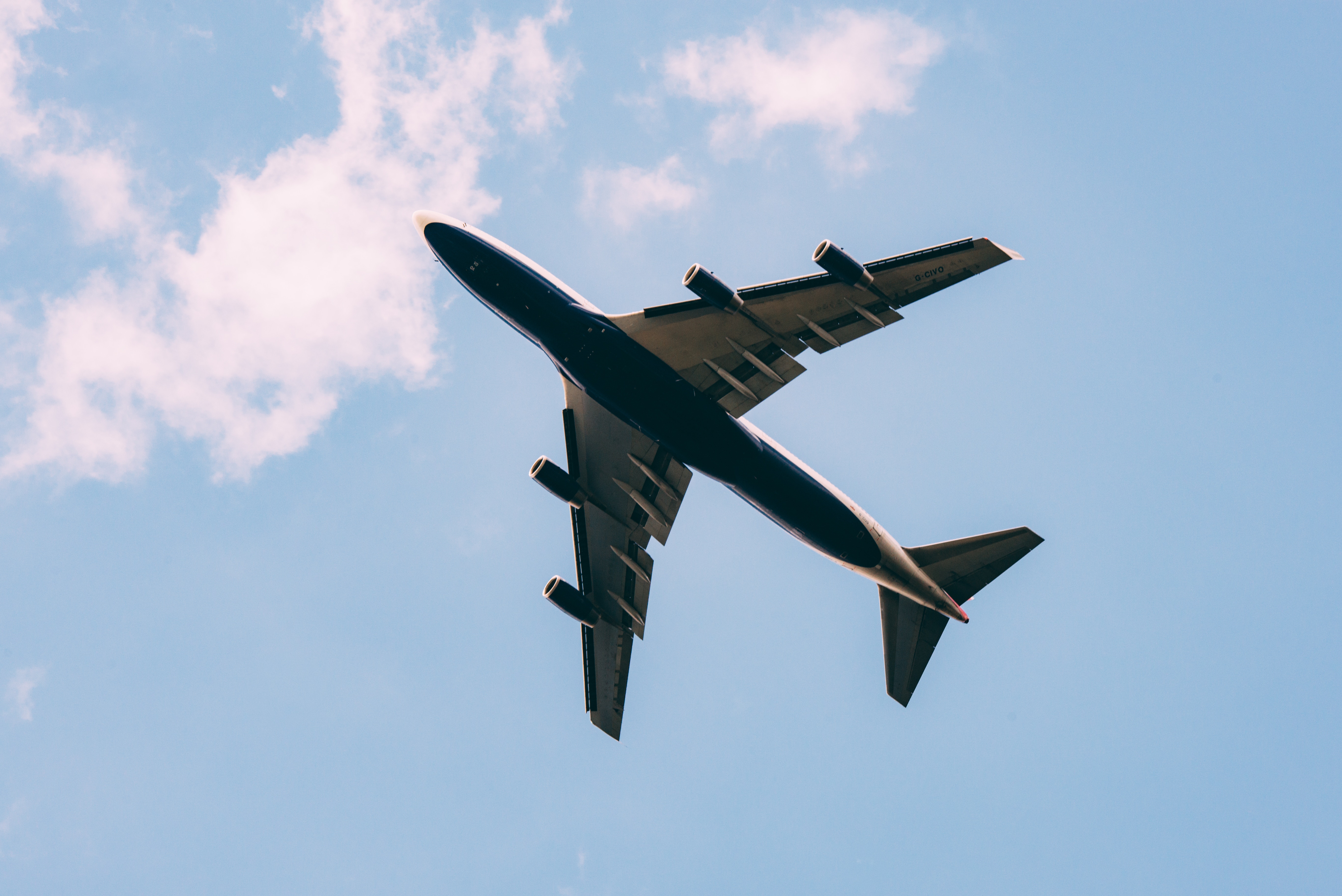 plane flying through sky to coastal destination