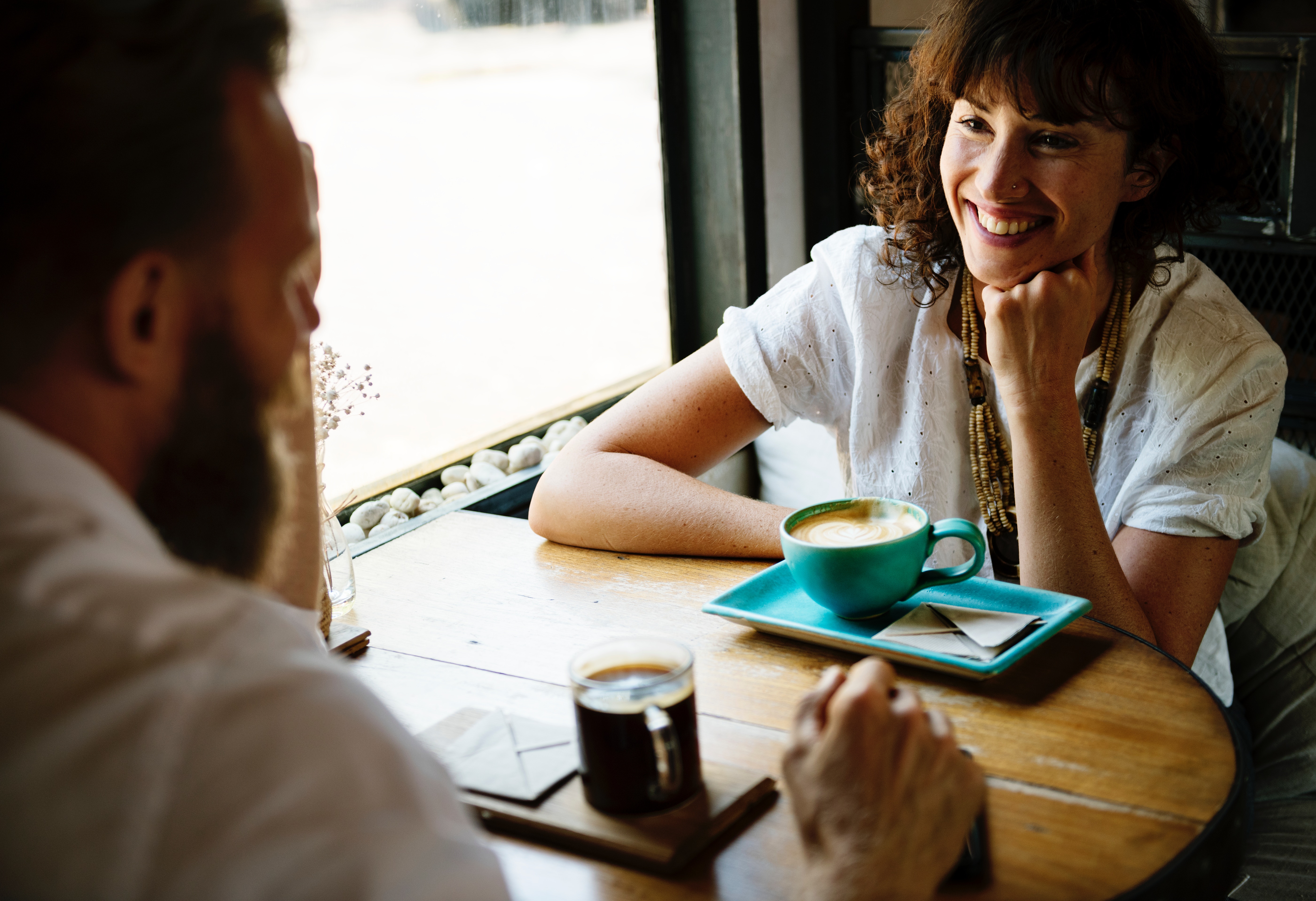 man and woman having a meeting in a coffee shop