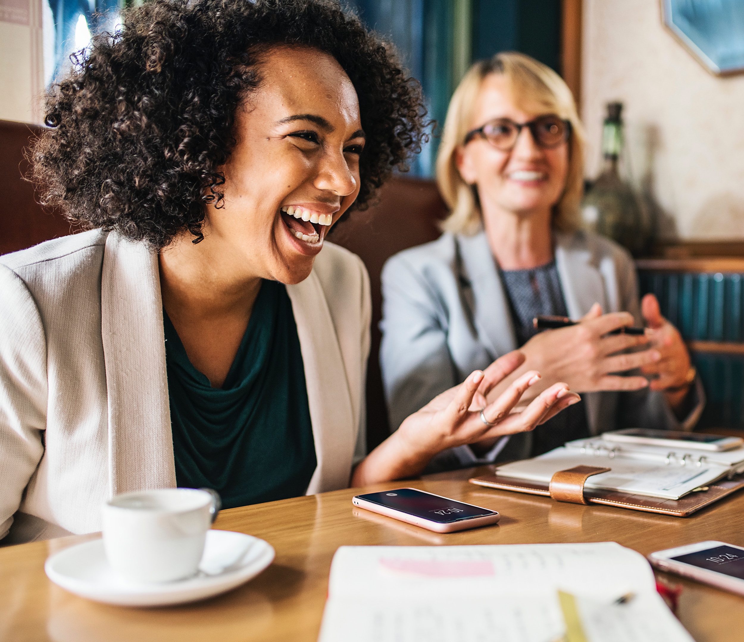 women drinking coffee and laughing