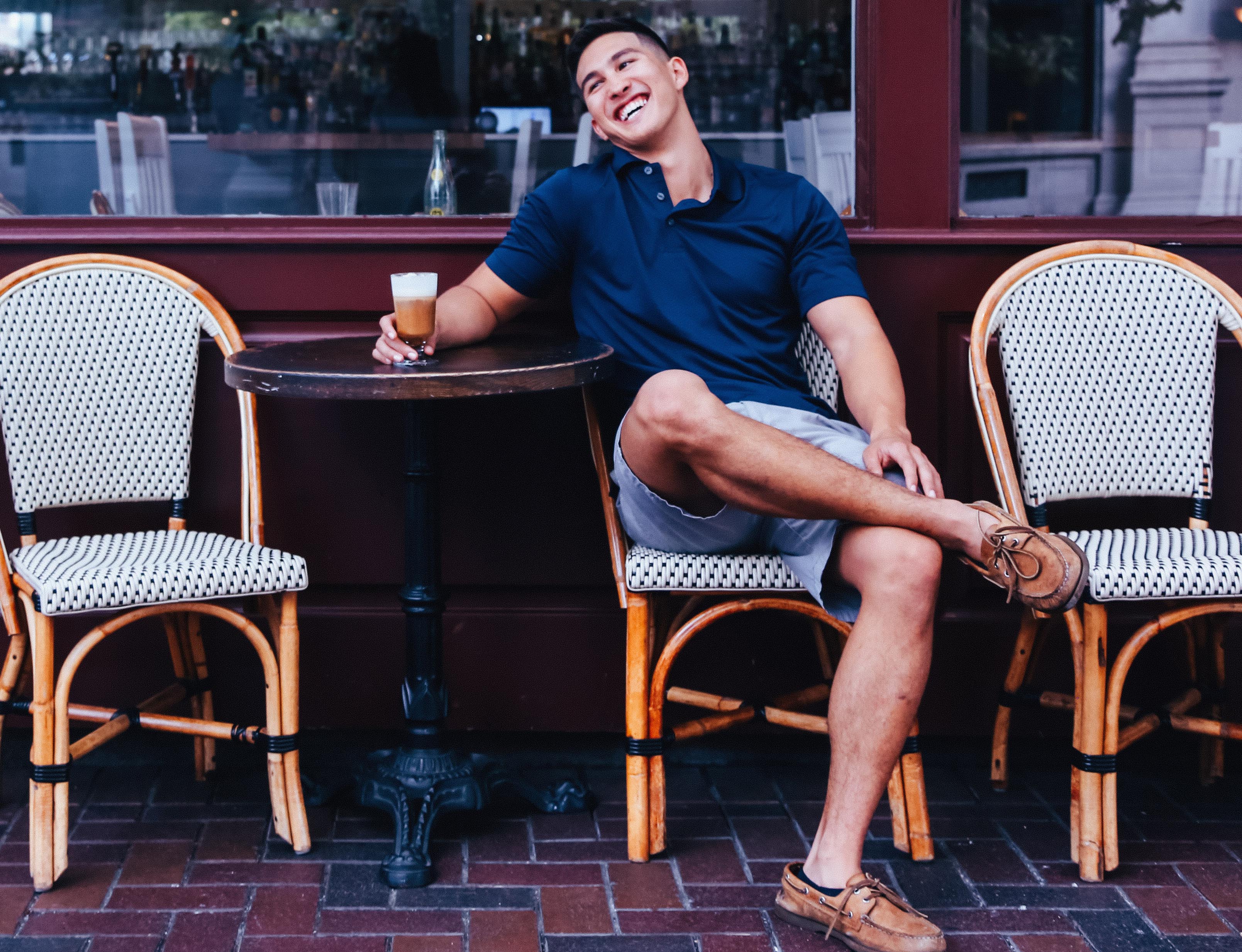 happy man in front of cafe