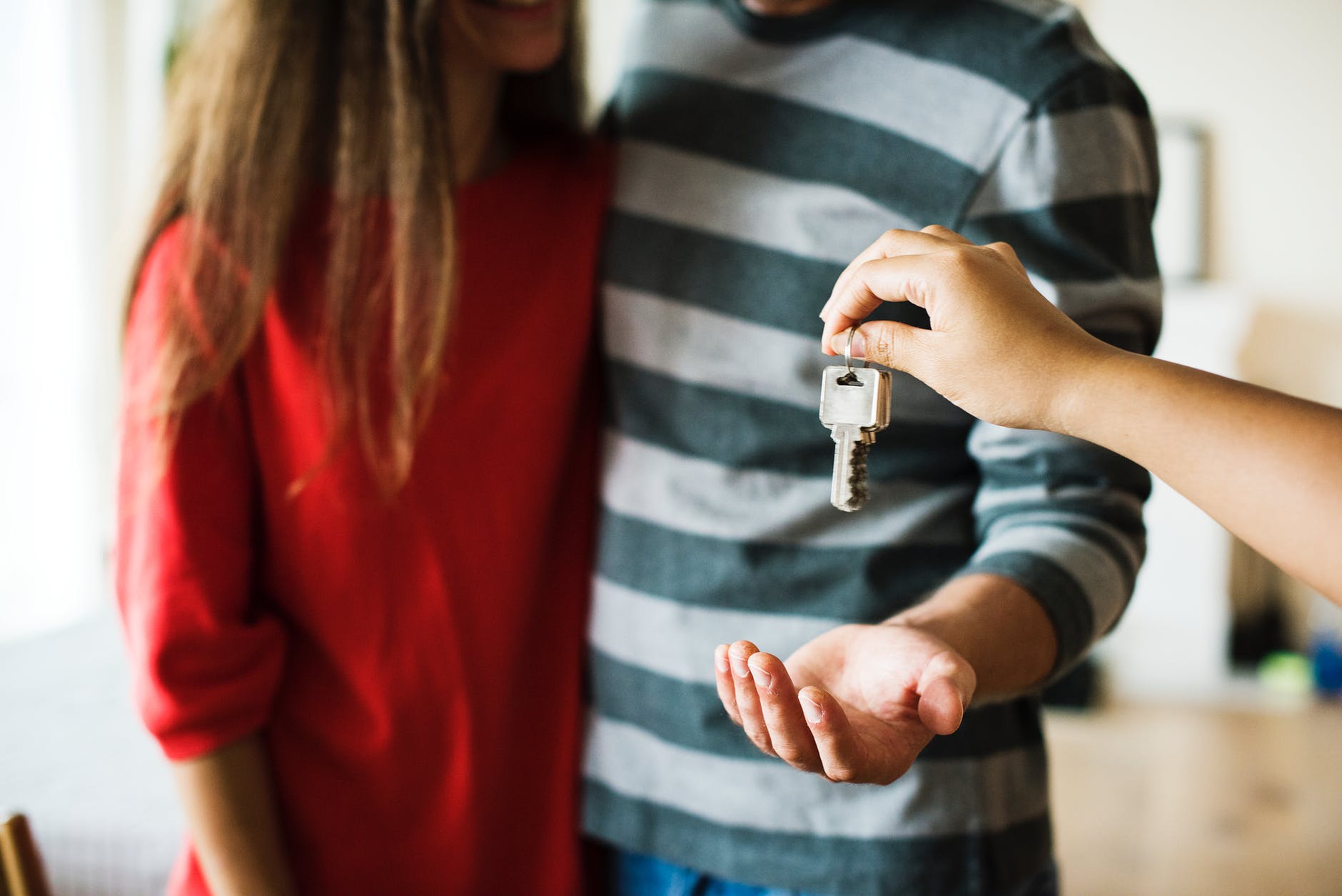 People receiving keys to their property asset